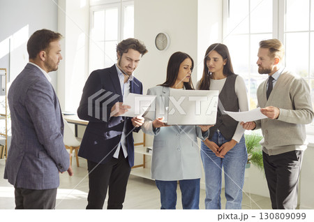 Business Team Working Together With Documents And Laptop 130809099