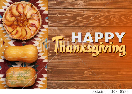 Cozy Thanksgiving celebration with pumpkin and apple pie on wooden table Cozy Thanksgiving celebration with pumpkin and apple pie on wooden table 130810529