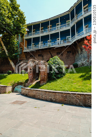 Charming architectural ruins and vibrant greenery at a historical site in a sunny setting 130810535