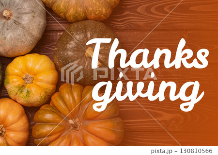 Warm autumn pumpkins decorate a rustic wooden table for a Thanksgiving celebration 130810566
