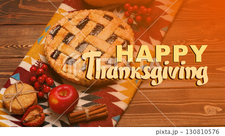 Celebrating Thanksgiving with a festive pie and autumn decorations on a wooden table Celebrating Thanksgiving with a festive pie and autumn decorations on a wooden table 130810576