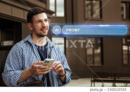 Man using smartphone with futuristic AI interface in urban setting during daylight hours Man using smartphone with futuristic AI interface in urban setting during daylight hours 130810585