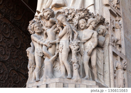 Intricate sculptural group depicting Adam, Eve and Serpent at Notre-Dame de Paris Intricate sculptural group depicting Adam, Eve and Serpent at Notre-Dame de Paris 130811083
