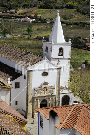 Church and rooftops in Obidos town, Portugal with scenic countryside view 130811121