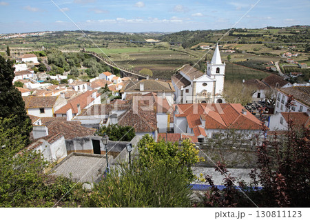 Church and rooftops in Obidos town, Portugal with scenic countryside view 130811123