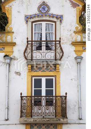 Charming historic building in Obidos, Portugal, featuring intricate balconies Charming historic building in Obidos, Portugal, featuring intricate balconies 130811144