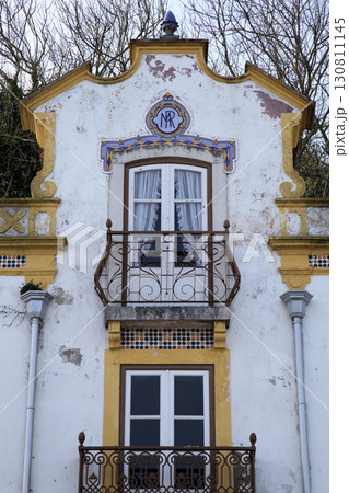 Charming historic building in Obidos, Portugal, featuring intricate balconies Charming historic building in Obidos, Portugal, featuring intricate balconies 130811145
