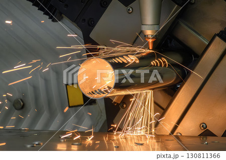 Close up scene the fiber laser cutting machine cut the stainless steel tube control by CNC program. 130811366