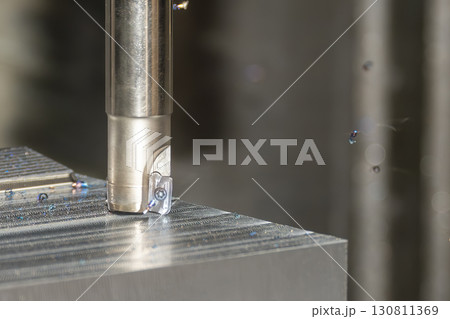 Close up scene the CNC milling machine rough cutting the mold parts by indexable tools. Close up scene the CNC milling machine rough cutting the mold parts by indexable tools. 130811369