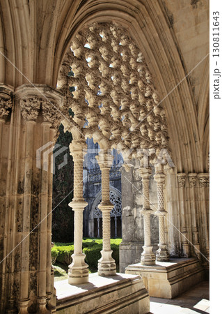 Intricate stone arches and columns in the beautiful cloister at Batalha monastery 130811643
