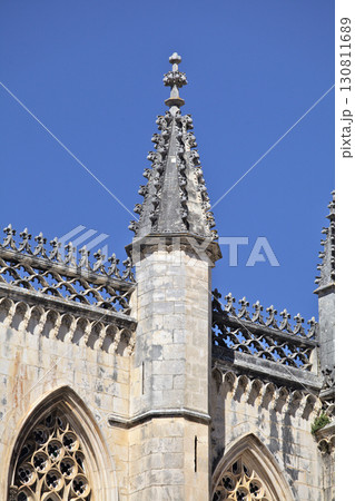 Detailed architecture of Batalha monastery towers against clear blue sky Detailed architecture of Batalha monastery towers against clear blue sky 130811689