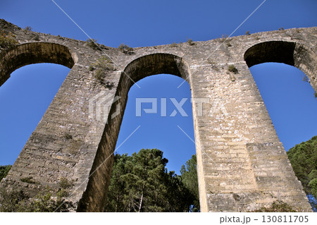 Exploration of Pegoes Aqueduct in Portugal's serene landscape 130811705