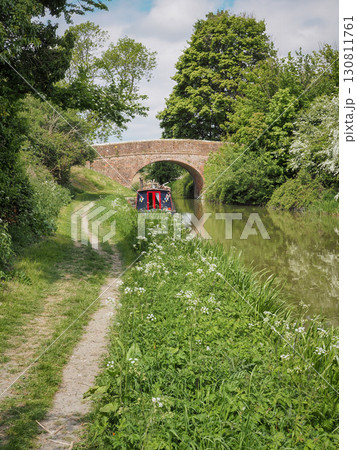 Canal boat and bridge on Kennet and Avon Canal, Stanton St Bernard, Wiltshire 130811761