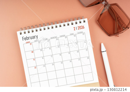 2026 February desk calendar with brown sunglasses. Directly above. Calendar and reminder concept. 130812214
