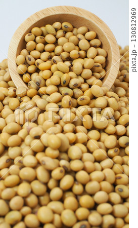 Close-up of soybeans spilling from a wooden bowl, representing organic legumes, healthy food ingredients, plant-based protein, and agriculture products. Close-up of soybeans spilling from a wooden bowl, representing organic legumes, healthy food ingredients, plant-based protein, and agriculture products. 130812969