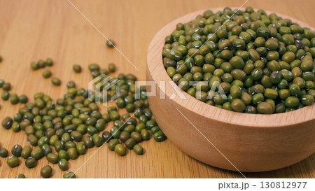 Mung beans in wooden bowl on wooden surfaceMung beans in wooden bowl on wooden surface Mung beans in wooden bowl on wooden surfaceMung beans in wooden bowl on wooden surface 130812977