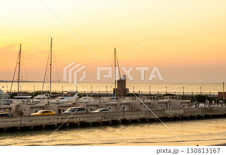 Calm on coast. The sky in evening. Water. Sunset sky clouds. Seaport of Italian city of Rimini in Summer Calm on coast. The sky in evening. Water. Sunset sky clouds. Seaport of Italian city of Rimini in Summer 130813167