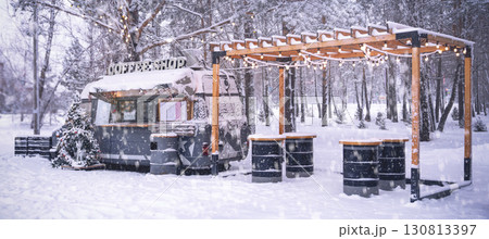 A charming and cozy food truck is beautifully set in a serene winter landscape, surrounded by stunning snowy scenery, Street food in winter is a snow-covered coffee shop bus in a beautiful place under A charming and cozy food truck is beautifully set in a serene winter landscape, surrounded by stunning snowy scenery, Street food in winter is a snow-covered coffee shop bus in a beautiful place under 130813397