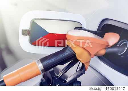 The Czech flag on the lid of the gas tank of a car at a gas station in close-up. High or low prices at Czech gas stations. Problems with the quality of gasoline and diesel fuel and their shortage in The Czech flag on the lid of the gas tank of a car at a gas station in close-up. High or low prices at Czech gas stations. Problems with the quality of gasoline and diesel fuel and their shortage in 130813447