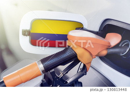 The flag of Colombia on the lid of the gas tank of a car at a gas station in close-up. High or low prices at Colombian gas stations. Problems with the quality of gasoline and diesel fuel and their The flag of Colombia on the lid of the gas tank of a car at a gas station in close-up. High or low prices at Colombian gas stations. Problems with the quality of gasoline and diesel fuel and their 130813448