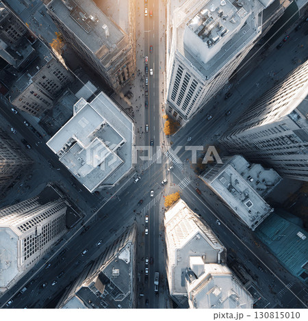 Aerial view capturing a modern citys bustling intersection. Tall buildings create depth, showing urban density and transportation. Great for business or architecture. 130815010