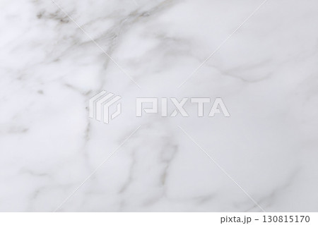 Elegant marble texture, pristine white with delicate grey veining. Ideal for backgrounds, overlays, or design elements demanding a touch of sophisticated minimalism. 130815170