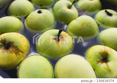 Fresh green apples in bowl. Ripe apples in water. Autumn harvest. Organic fruits background. Heap of green apples. Raw dieting. Natural vitamin. Healthy eating concept. Natural snack. 130816574