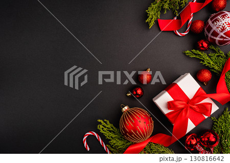 Christmas Gift with Red Ornaments and Greenery on Black 130816642