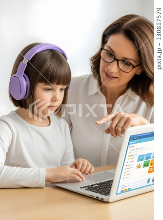 Neurodivergent kid girl in educational therapy using laptop with therapist guidance wearing purple headphones for focus autism spectrum learning and inclusion awareness 130817579