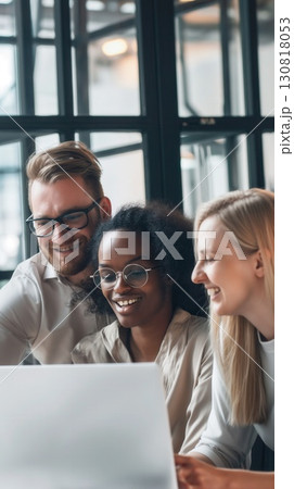 smiling diverse coworkers collaborating on laptop in modern office setting with upbeat atmosphere concept of corporate success, teamwork marketing 130818053