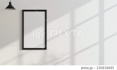 Vintage black frame with intricate details on white wall surrounded by shadows from plants Vintage black frame with intricate details on white wall surrounded by shadows from plants 130818085