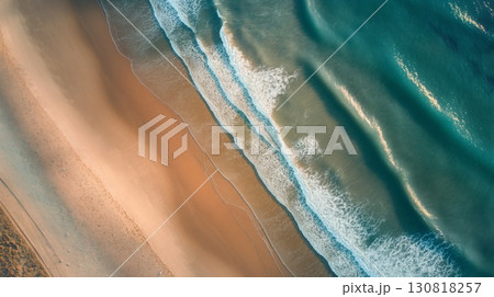 Aerial view beach gentle waves meeting sandy shore soft evening light Aerial view beach gentle waves meeting sandy shore soft evening light 130818257