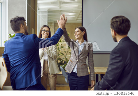 Business people high five happy team celebration or office greeting Business people high five happy team celebration or office greeting 130818546