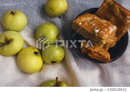 Apple pie with powdered sugar with green apples. Autumn dessert. Homemade dessert. Apple pie with cinnamon and fresh apple fruits. Country still life. Sweet dessert. Homely vibes. Apple pie with powdered sugar with green apples. Autumn dessert. Homemade dessert. Apple pie with cinnamon and fresh apple fruits. Country still life. Sweet dessert. Homely vibes. 130818632