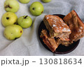 Apple pie with powdered sugar with green apples. Autumn dessert. Homemade dessert. Apple pie with cinnamon and fresh apple fruits. Country still life. Sweet dessert. Homely vibes.  130818634