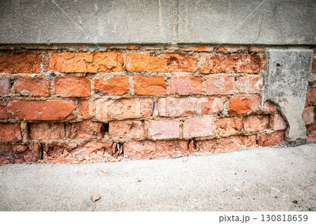 Old damaged brick wall with weathered mortar surface texture 130818659