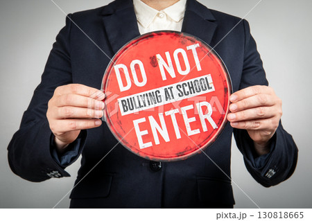 Person holding anti bullying school signboard concept 130818665