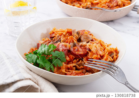 Bigos, Polish dish bigos, on the table, pan with stewed meat, with cabbage, chorizo sausages, mushrooms, homemade, without people, 130818738