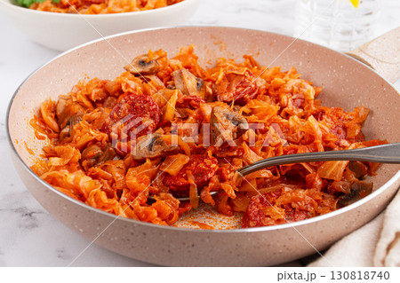 Bigos, Polish dish bigos, on the table, pan with stewed meat, with cabbage, chorizo sausages, mushrooms, homemade, without people, 130818740