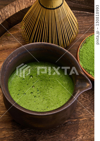 Traditional Matcha Preparation. Close-up of matcha tea in a bowl with a whisk and powder 130818993