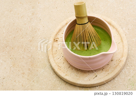 Matcha Preparation. A bamboo whisk in a bowl of frothy matcha tea Matcha Preparation. A bamboo whisk in a bowl of frothy matcha tea 130819020