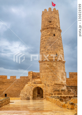 Inner yards and watch tower with tunisian flag on the top of Ribat of Monastir under cloudy skies, Monastir, Monastir Governorate, Tunisia Inner yards and watch tower with tunisian flag on the top of Ribat of Monastir under cloudy skies, Monastir, Monastir Governorate, Tunisia 130819399