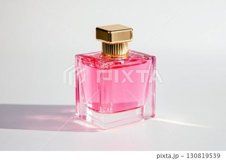 Pink perfume bottle. Elegant glass perfume bottle with a soft pink liquid. Mock up of minimal transparent glass bottle of perfume with a golden cap. Plain white background. Stylish perfumeries banner Pink perfume bottle. Elegant glass perfume bottle with a soft pink liquid. Mock up of minimal transparent glass bottle of perfume with a golden cap. Plain white background. Stylish perfumeries banner 130819539