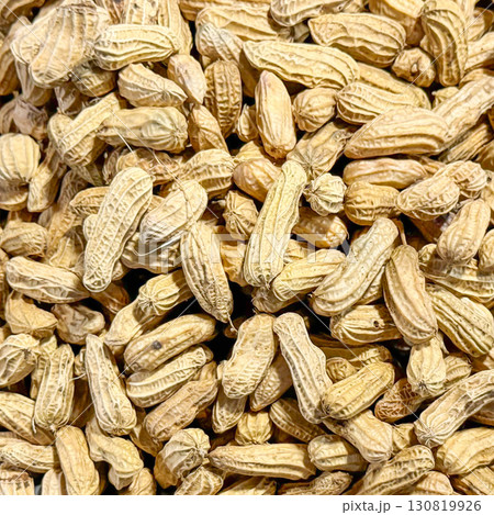 Backdrop with close-up of unshelled peanuts of earthy tones, symbolizing natural, whole foods and nutritious snacking options, evoking the simplicity and wholesomeness of farm-fresh produce Backdrop with close-up of unshelled peanuts of earthy tones, symbolizing natural, whole foods and nutritious snacking options, evoking the simplicity and wholesomeness of farm-fresh produce 130819926