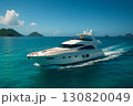 Luxury yacht cruising through clear turquoise waters under a bright blue sky with distant islands 130820049