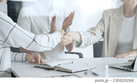 Business people shaking hands after successful negotiation, colleagues clapping, celebrating agreement in modern office headset. Handshake concept, close up view Business people shaking hands after successful negotiation, colleagues clapping, celebrating agreement in modern office headset. Handshake concept, close up view 130820268