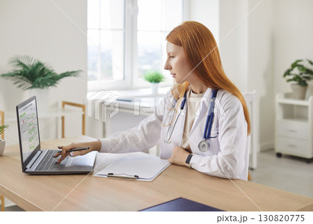 Doctor Or Nurse Working On A Laptop In A Medical Office 130820775
