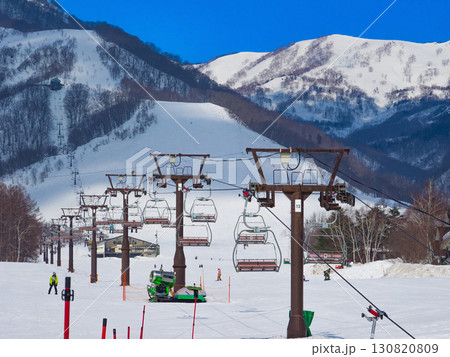 広大なゲレンデのチェアリフトの列と雪山の風景 (長野県、白馬、栂池高原) 130820809