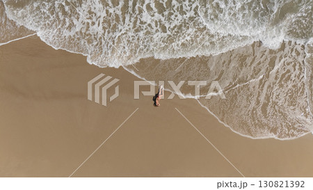Pregnant Woman Relaxing by the Ocean Aerial Beach Photography 130821392