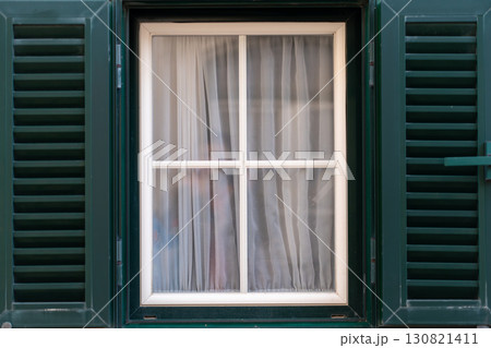 Window With Closed Shutters and Sheer Curtains in Window With Closed Shutters and Sheer Curtains in 130821411